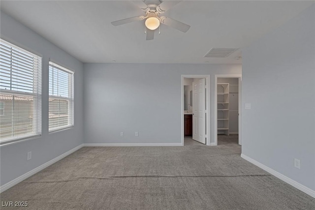 1130 Blissful Plains Ave, North Las Vegas, NV 89086 - unfurnished bedroom featuring carpet flooring, a spacious closet, baseboards, and ceiling fan
