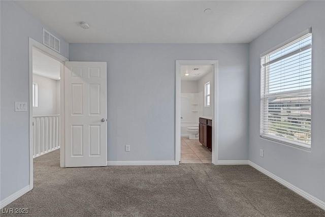 1130 Blissful Plains Ave, North Las Vegas, NV 89086 - unfurnished bedroom featuring light carpet, baseboards, and ensuite bathroom
