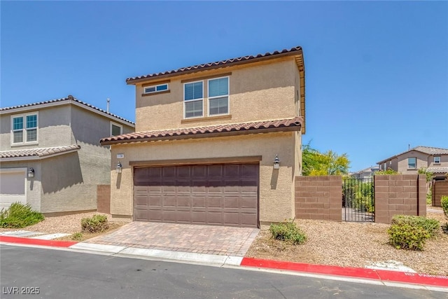 1130 Blissful Plains Ave, North Las Vegas, NV 89086 - mediterranean / spanish house with a garage, stucco siding, a tiled roof, and decorative driveway