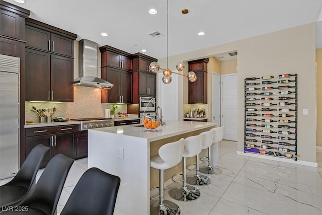 881 Barrhead Ave, Henderson, NV 89012 - kitchen with wall chimney range hood, appliances with stainless steel finishes, light countertops, tasteful backsplash, and a breakfast bar area