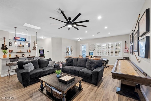 219 Windsong Dr, Henderson, NV 89074 - living area with bar area, light wood-type flooring, ceiling fan, baseboards, and recessed lighting