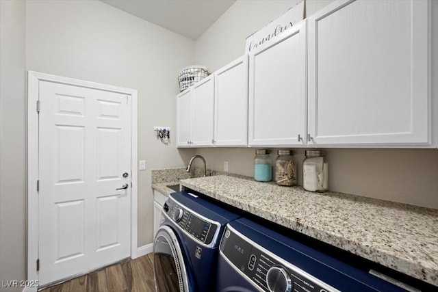 219 Windsong Dr, Henderson, NV 89074 - laundry area featuring washer and dryer, cabinet space, dark wood-type flooring, and baseboards