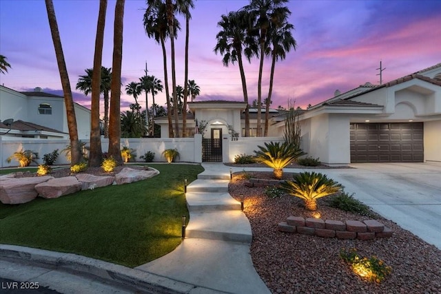 219 Windsong Dr, Henderson, NV 89074 - view of front of property with stucco siding, a fenced front yard, driveway, a garage, and a gate