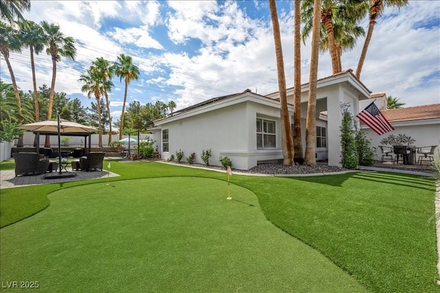 219 Windsong Dr, Henderson, NV 89074 - view of yard featuring a putting green, a gazebo, and a patio area