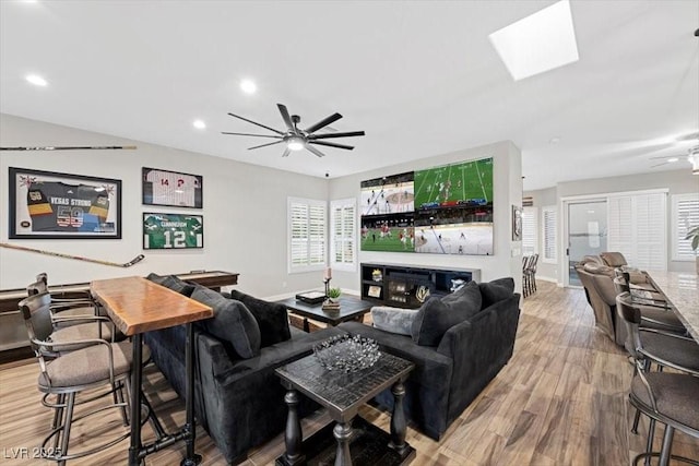 219 Windsong Dr, Henderson, NV 89074 - living area with a ceiling fan, wood finished floors, baseboards, recessed lighting, and a skylight