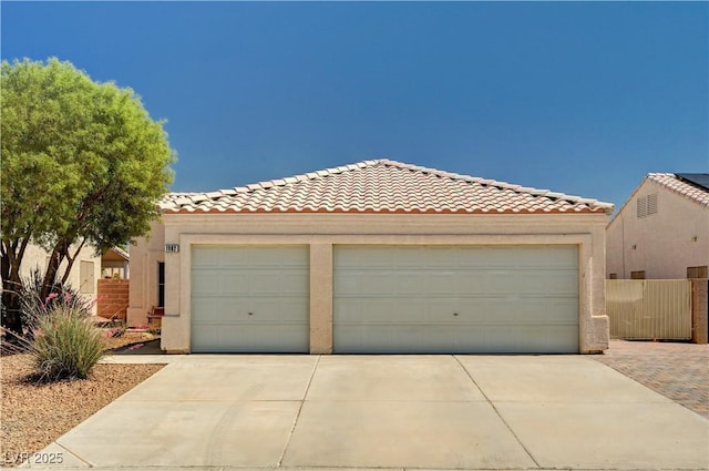 1902 Panther Pl, North Las Vegas, NV 89031 - view of front facade with a tile roof, driveway, a garage, and stucco siding