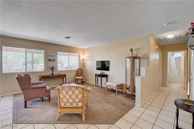 1902 Panther Pl, North Las Vegas, NV 89031 - living room with a textured ceiling, baseboards, light tile patterned floors, and light colored carpet