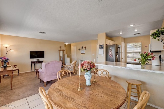 1902 Panther Pl, North Las Vegas, NV 89031 - dining area featuring light colored carpet, a textured ceiling, baseboards, light tile patterned floors, and recessed lighting