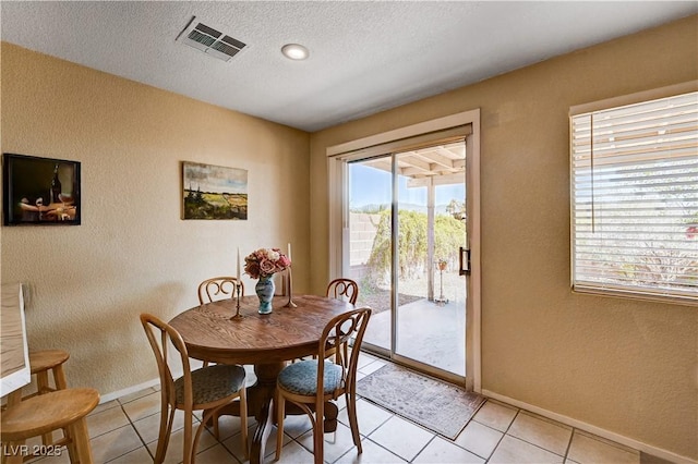 1902 Panther Pl, North Las Vegas, NV 89031 - dining space with a textured wall, baseboards, a textured ceiling, and light tile patterned floors