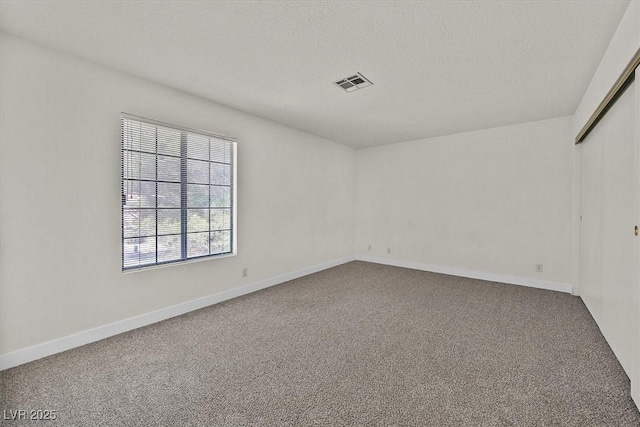 2633 S Durango Dr Unit 204, Las Vegas, NV 89117 - carpeted spare room featuring baseboards and a textured ceiling