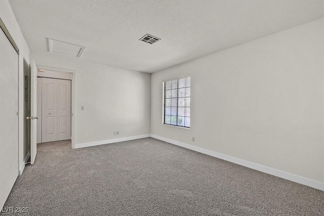 2633 S Durango Dr Unit 204, Las Vegas, NV 89117 - unfurnished room with carpet floors, baseboards, a textured ceiling, and attic access