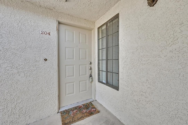 2633 S Durango Dr Unit 204, Las Vegas, NV 89117 - doorway to property with stucco siding