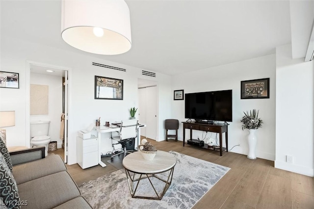3111 Bel Air Dr Unit 7F, Las Vegas, NV 89109 - living room with wood finished floors and a desk