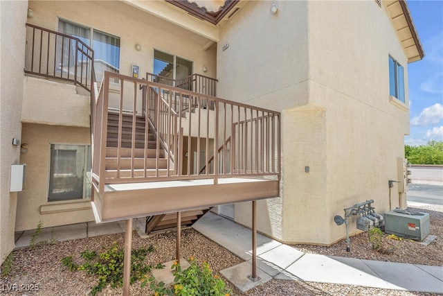 4800 Grey Wolf Ln Unit 202, Las Vegas, NV 89149 - rear view of property with stairway and stucco siding