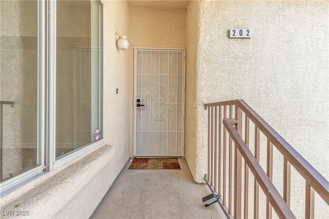 4800 Grey Wolf Ln Unit 202, Las Vegas, NV 89149 - view of exterior entry featuring stucco siding and a balcony