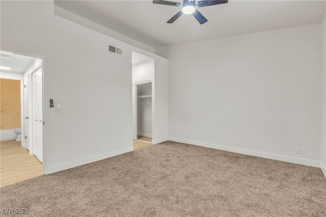 4800 Grey Wolf Ln Unit 202, Las Vegas, NV 89149 - unfurnished bedroom with light carpet, a closet, a walk in closet, and ceiling fan
