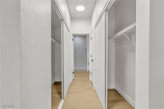 4800 Grey Wolf Ln Unit 202, Las Vegas, NV 89149 - hallway featuring light wood finished floors and a textured wall