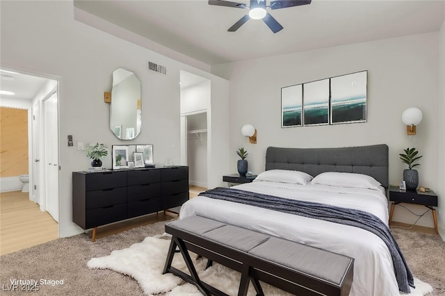 4800 Grey Wolf Ln Unit 202, Las Vegas, NV 89149 - bedroom featuring a closet, a walk in closet, light carpet, and a ceiling fan
