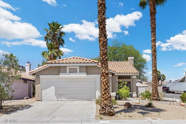 6997 Ray Charles Ln, Las Vegas, NV 89119 - mediterranean / spanish house featuring a tile roof, stucco siding, concrete driveway, and an attached garage