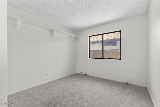 6997 Ray Charles Ln, Las Vegas, NV 89119 - carpeted spare room featuring a textured ceiling and baseboards