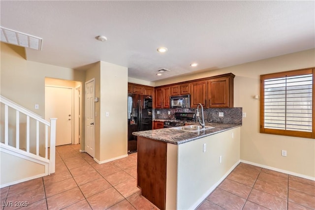 9073 Spoonbill Ridge Pl, Las Vegas, NV 89143 - kitchen with black appliances, a sink, light tile patterned flooring, a peninsula, and tasteful backsplash