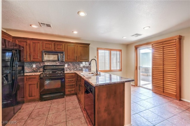 9073 Spoonbill Ridge Pl, Las Vegas, NV 89143 - kitchen featuring black appliances, a sink, a peninsula, backsplash, and light stone countertops
