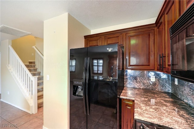 9073 Spoonbill Ridge Pl, Las Vegas, NV 89143 - kitchen featuring black fridge, tasteful backsplash, stone counters, and light tile patterned floors