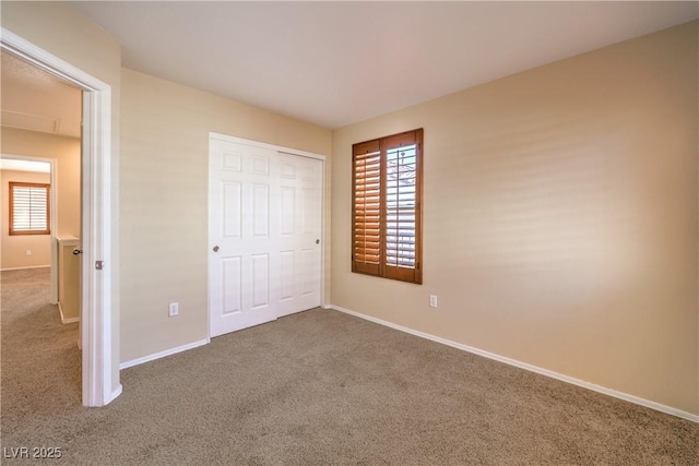 9073 Spoonbill Ridge Pl, Las Vegas, NV 89143 - unfurnished bedroom with carpet floors, multiple windows, baseboards, and a closet