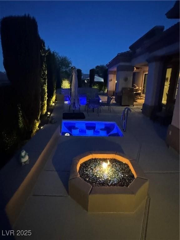 4208 Agosta Luna Pl, Las Vegas, NV 89135 - pool at twilight with an outdoor fire pit and a patio