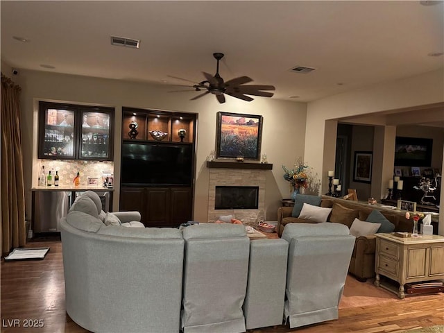 4208 Agosta Luna Pl, Las Vegas, NV 89135 - living room featuring ceiling fan, light wood-style floors, a glass covered fireplace, and bar area