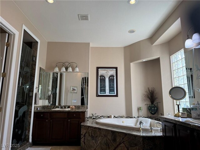 4208 Agosta Luna Pl, Las Vegas, NV 89135 - bathroom featuring two vanities, a garden tub, and a walk in shower