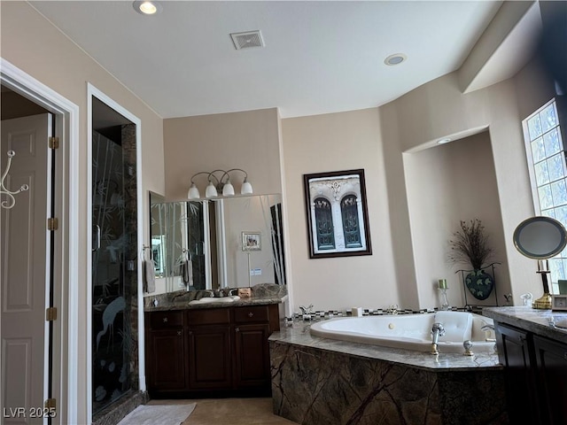4208 Agosta Luna Pl, Las Vegas, NV 89135 - full bathroom featuring two vanities, a bath, and a stall shower
