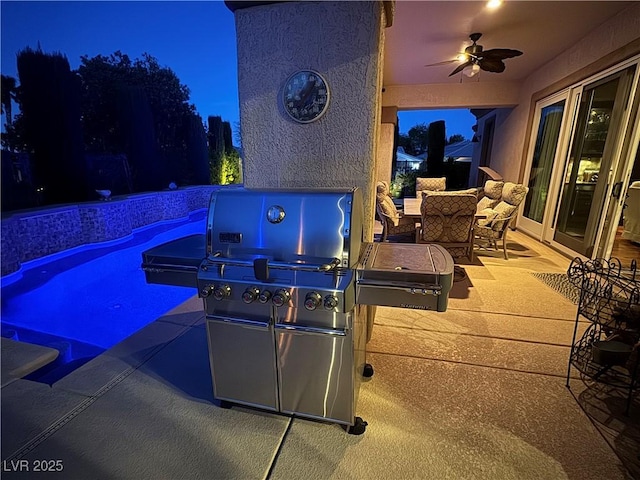 4208 Agosta Luna Pl, Las Vegas, NV 89135 - patio at night with ceiling fan, an outdoor pool, a patio, and a grill