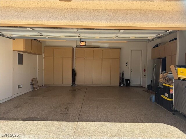 4208 Agosta Luna Pl, Las Vegas, NV 89135 - garage with a garage door opener and freestanding refrigerator