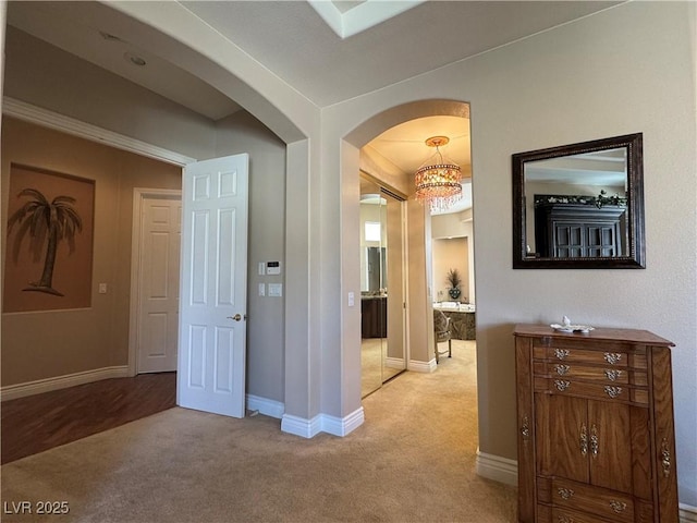 4208 Agosta Luna Pl, Las Vegas, NV 89135 - corridor featuring light carpet, arched walkways, and baseboards