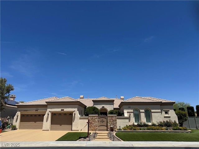 4208 Agosta Luna Pl, Las Vegas, NV 89135 - mediterranean / spanish-style home with stucco siding, a garage, concrete driveway, a tiled roof, and a gate