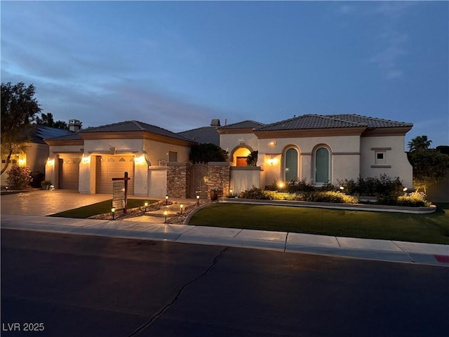 4208 Agosta Luna Pl, Las Vegas, NV 89135 - mediterranean / spanish-style home with stucco siding, a garage, a tile roof, and driveway