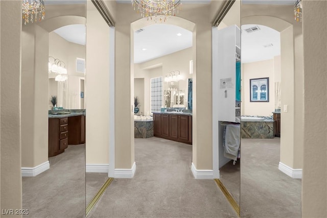 4208 Agosta Luna Pl, Las Vegas, NV 89135 - hall featuring light colored carpet, arched walkways, a chandelier, and baseboards