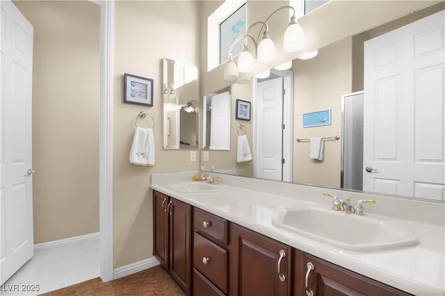 4208 Agosta Luna Pl, Las Vegas, NV 89135 - bathroom featuring double vanity, baseboards, and tile patterned flooring