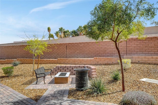 10985 Limeslice Ave Unit 2, Las Vegas, NV 89135 - fenced backyard with a fire pit and a patio
