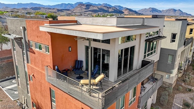 10985 Limeslice Ave Unit 2, Las Vegas, NV 89135 - back of house with stucco siding, a mountain view, and a ceiling fan