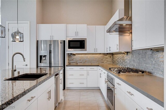10985 Limeslice Ave Unit 2, Las Vegas, NV 89135 - kitchen featuring wall chimney exhaust hood, stainless steel appliances, decorative backsplash, and light tile patterned floors