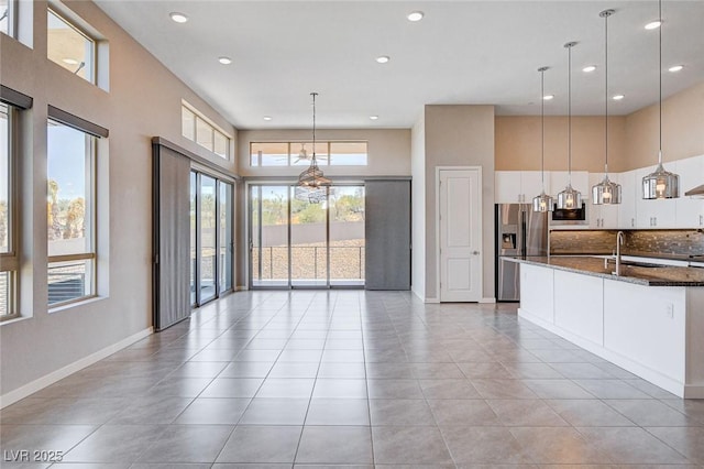 10985 Limeslice Ave Unit 2, Las Vegas, NV 89135 - unfurnished living room featuring recessed lighting, a towering ceiling, and light tile patterned floors