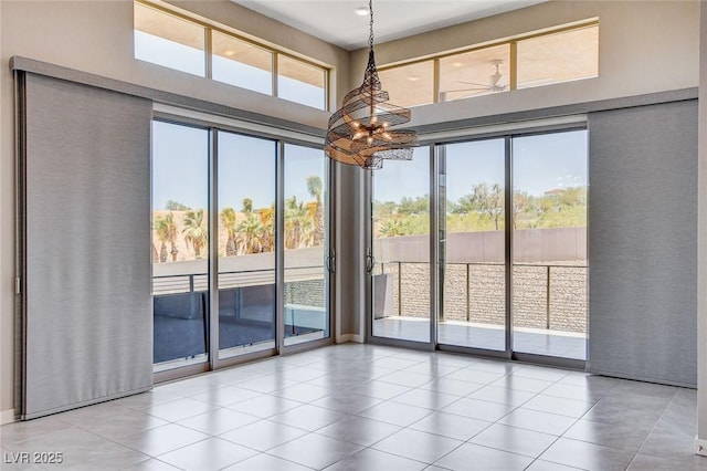 10985 Limeslice Ave Unit 2, Las Vegas, NV 89135 - unfurnished room with a high ceiling, a chandelier, and tile patterned flooring
