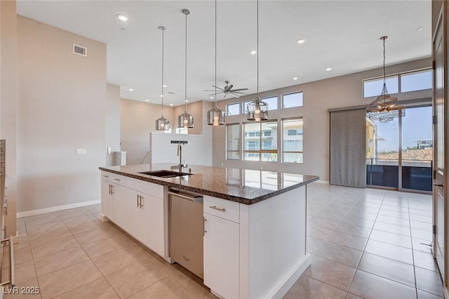10985 Limeslice Ave Unit 2, Las Vegas, NV 89135 - kitchen with stainless steel dishwasher, plenty of natural light, a center island with sink, white cabinets, and recessed lighting
