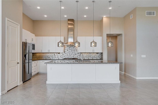 10985 Limeslice Ave Unit 2, Las Vegas, NV 89135 - kitchen with stainless steel refrigerator with ice dispenser, wall chimney exhaust hood, tasteful backsplash, dark stone counters, and an island with sink