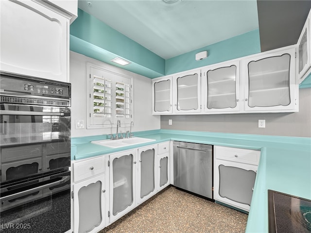 3212 Silver Saddle St, Las Vegas, NV 89169 - kitchen with black appliances, a sink, light countertops, white cabinets, and glass insert cabinets