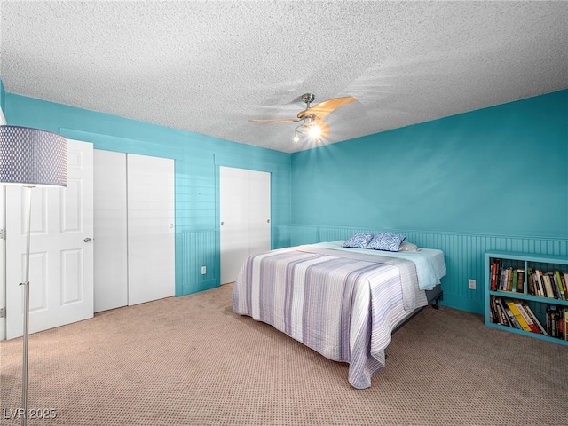 3212 Silver Saddle St, Las Vegas, NV 89169 - carpeted bedroom with wainscoting, a textured ceiling, and a ceiling fan