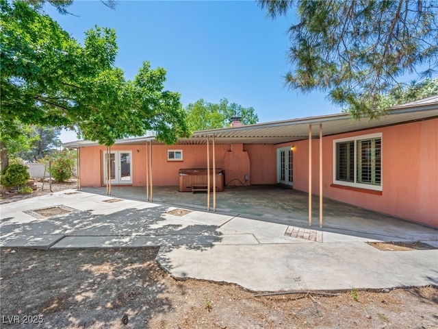 3212 Silver Saddle St, Las Vegas, NV 89169 - rear view of house featuring french doors, a hot tub, a chimney, and a patio area