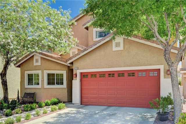 9370 Corkfish St, Las Vegas, NV 89178 - view of front of home with an attached garage, stucco siding, and driveway
